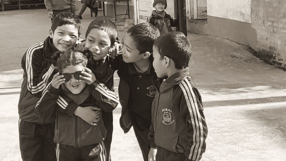 Boys laughing together in a school yard