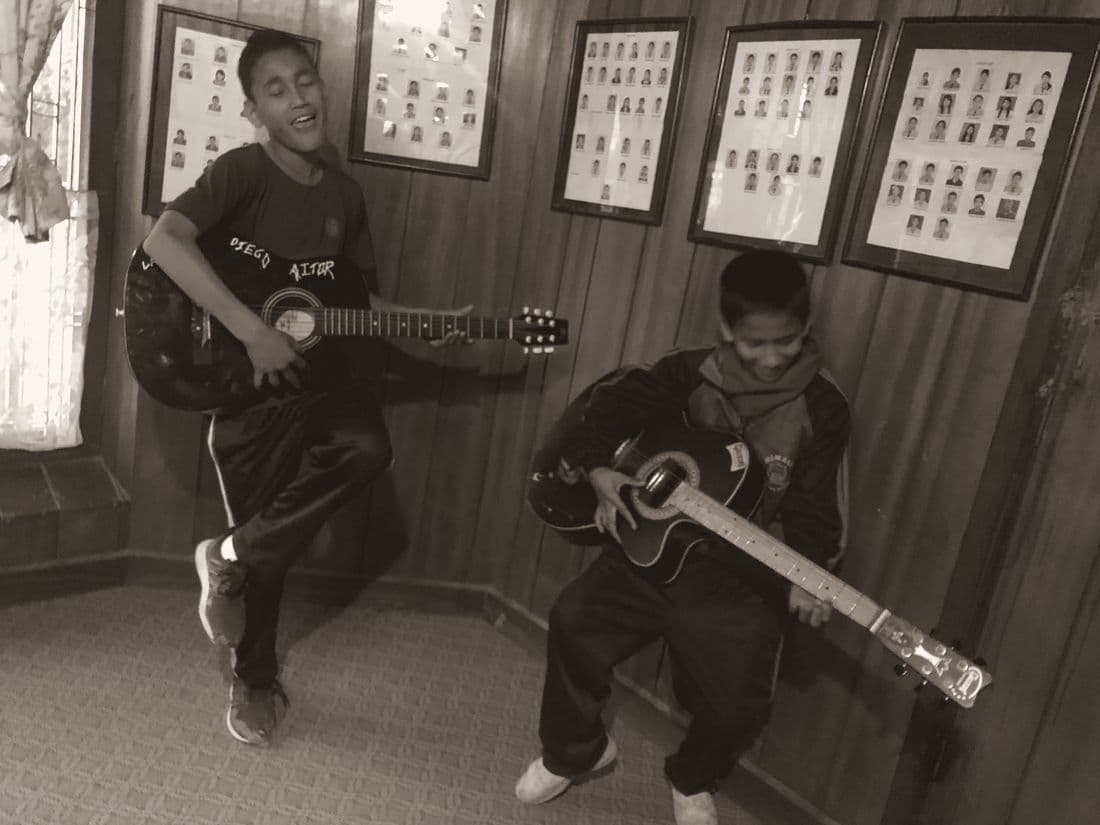 Two boys playing guitars