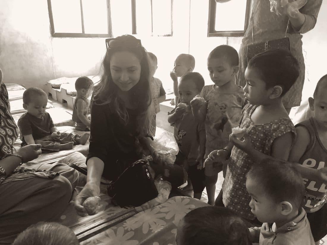 Pooja with small children at a nursery