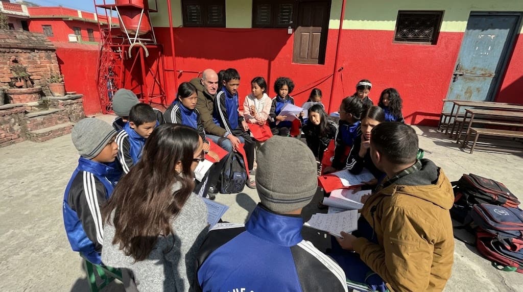 Pooja sitting with a group of children