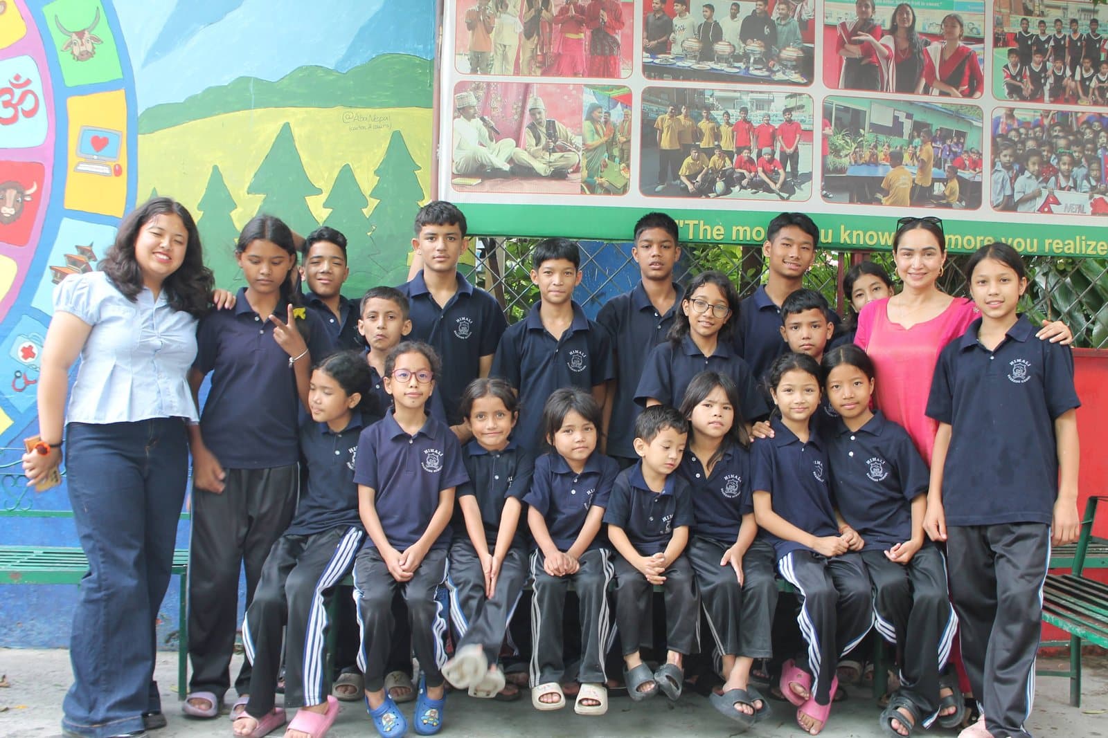 Pooja with a group of the children Bhagya Nepal supports, in school uniform outside their school